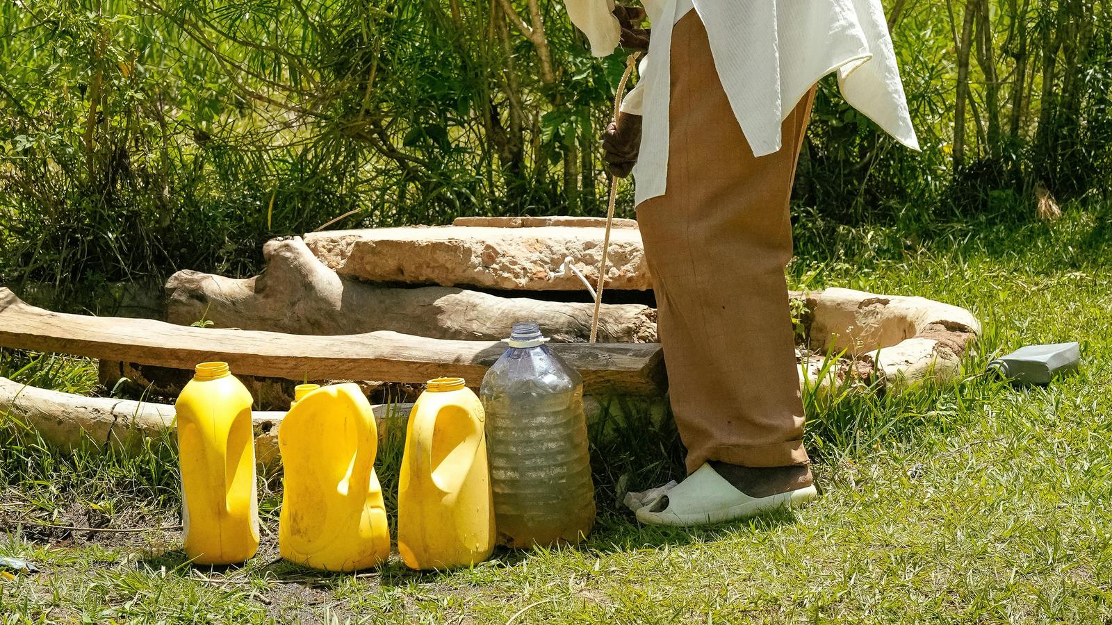 Field staff collecting water samples for laboratory analysis